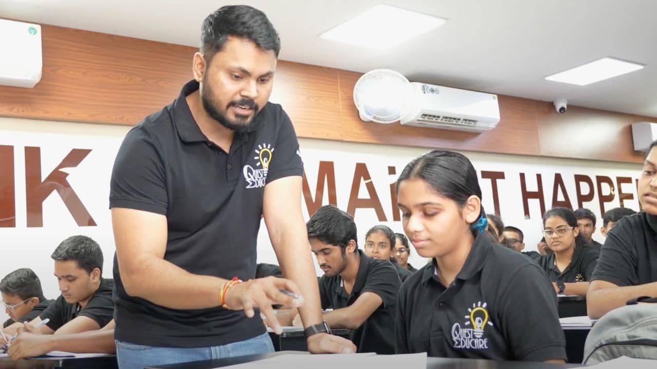 Deepak Sir helping a student during a Quest Educare class