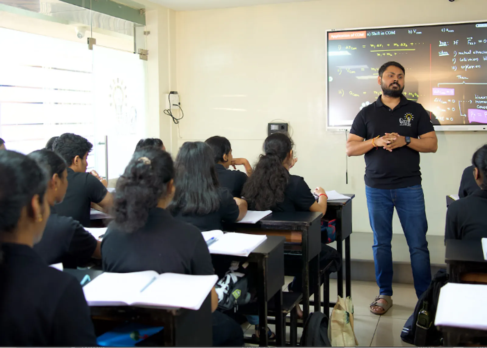 Deepak Sir at the board in a Quest Educare classroom