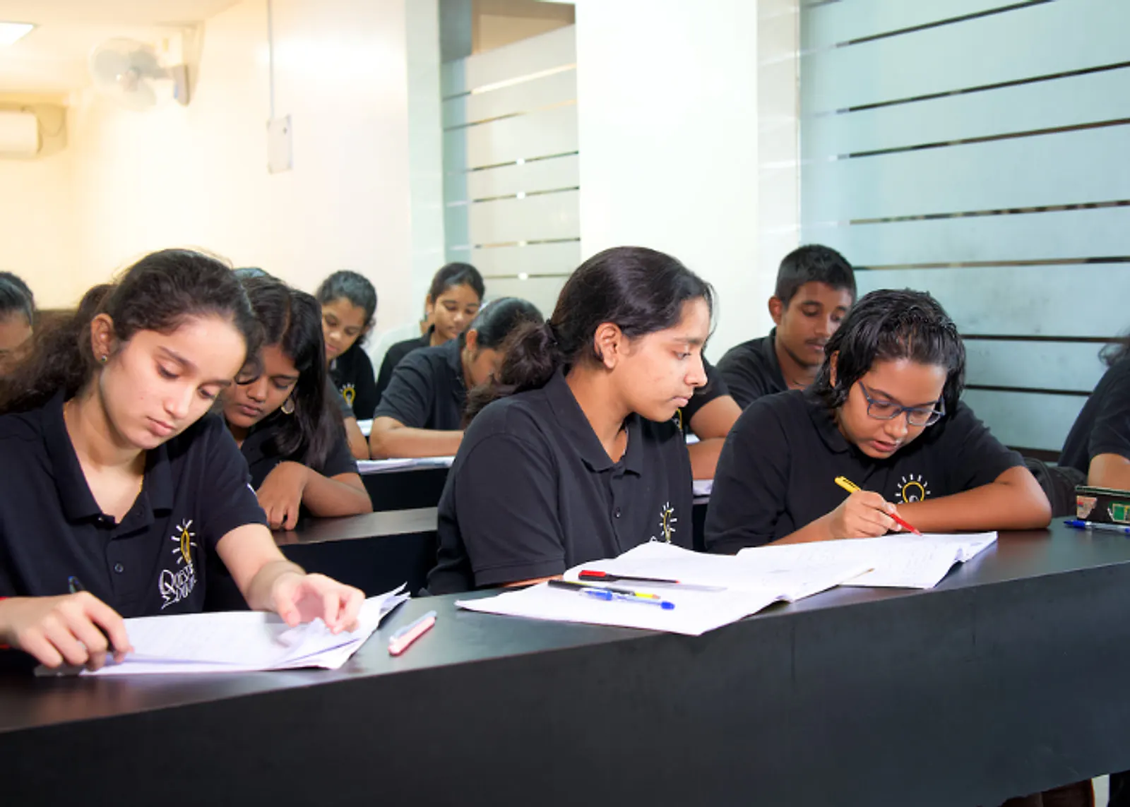 Students working through problems in a Quest Educare class