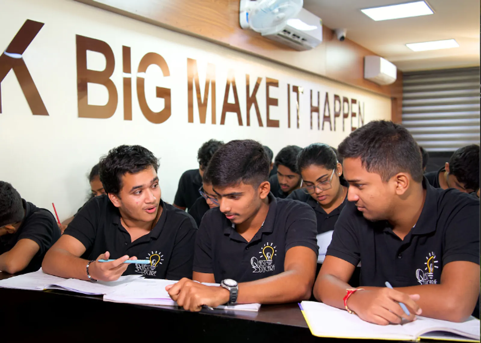Students taking notes in a Quest Educare class